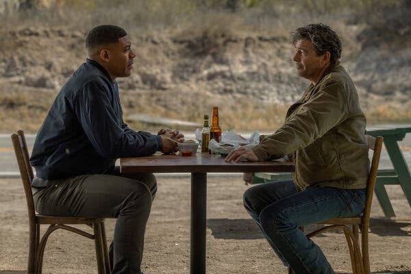 Lanterns Episode 1 Pilot still — Hal Jordan and John Stewart at a roadside table